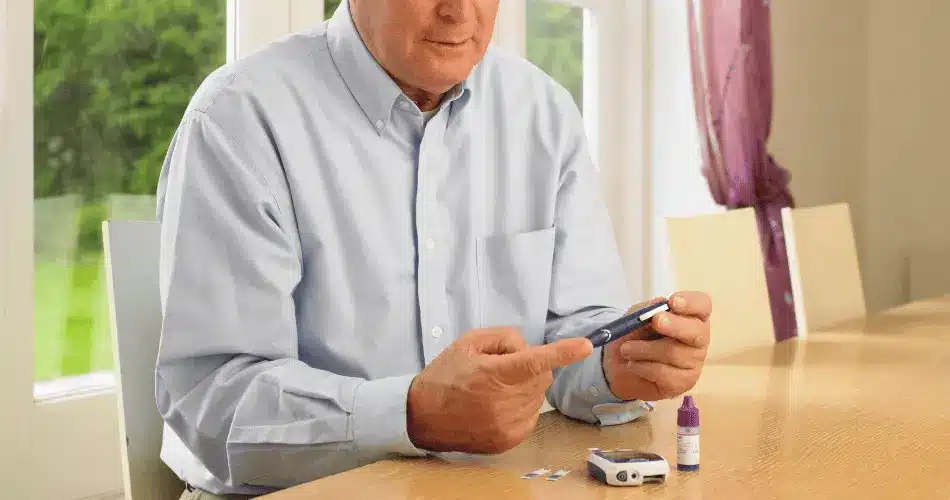 Man Using Glucometer For Diabetes Man Using Glucometer For Diabetes