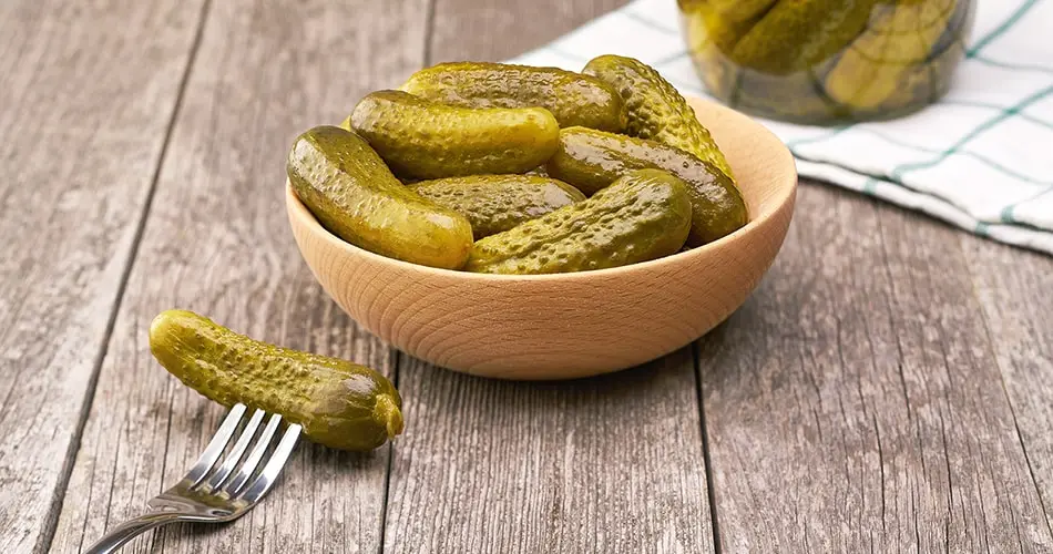 Table With A Bowl And Jar Of Pickles