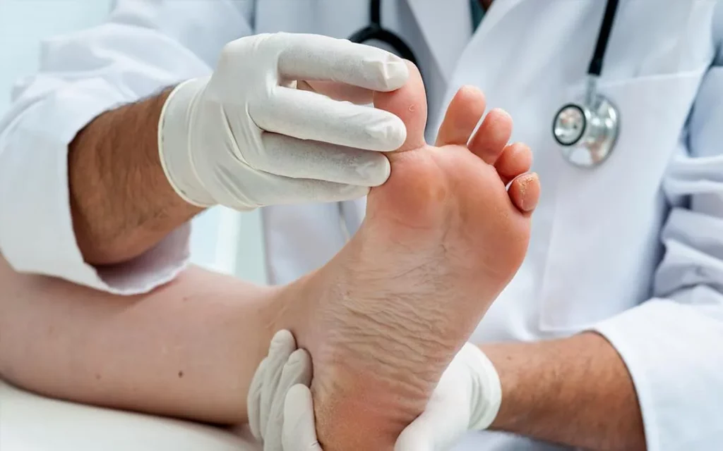 A Doctor Holding A Foot For Inspection