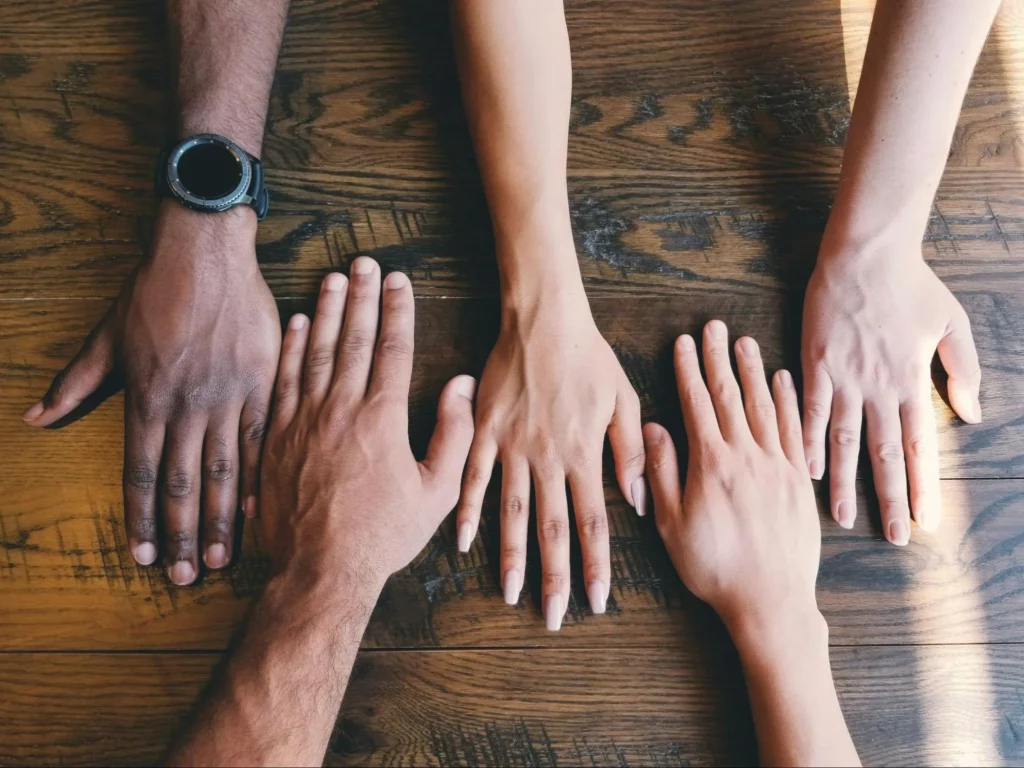 Image2 11Zon 5 A Group Of People'S Hands On A Table