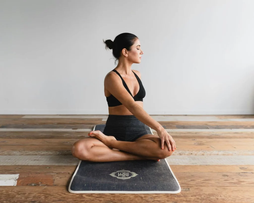 Image7 11Zon 4 A Woman Sitting On A Yoga Mat Turning Her Back