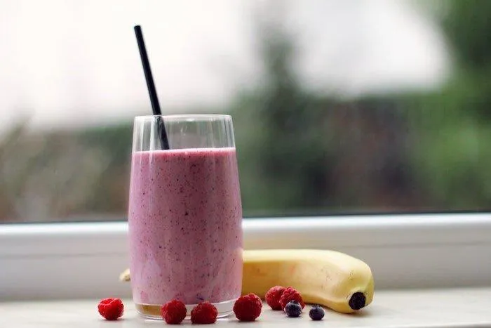 Image8 11Zon 10 A Glass Of Pink Smoothie With Straw Next To A Banana And Berries