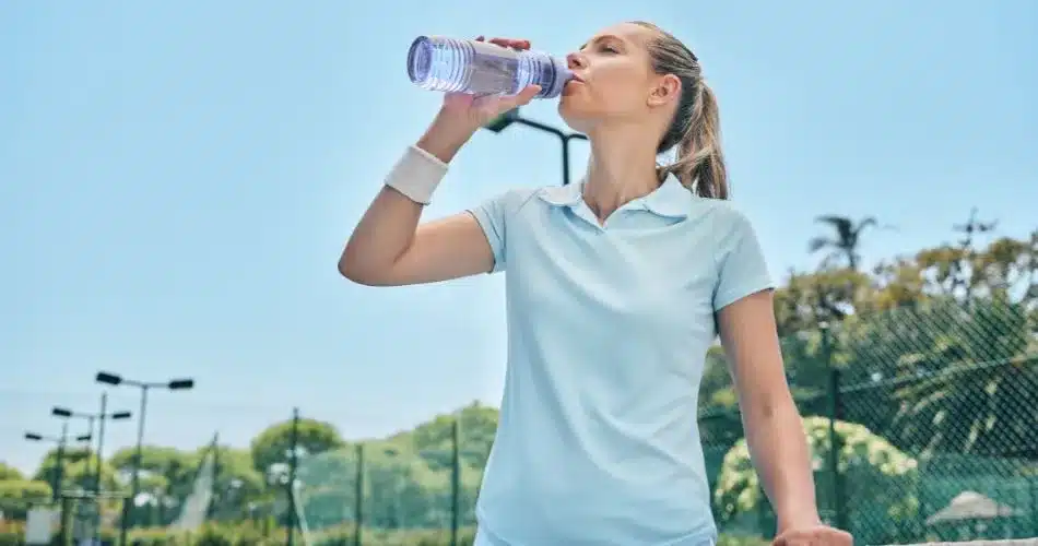 Drink Enough Water A Woman Drinking From A Water Bottle