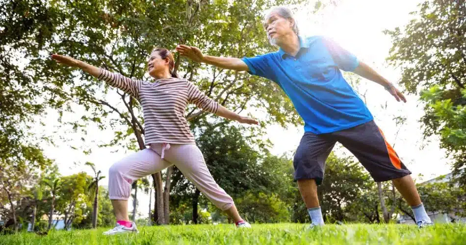Get Active To Reduce Cravings A Man And Woman Doing Yoga Outside