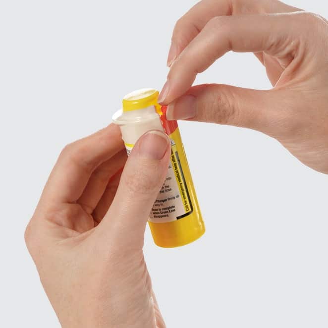 Preparing The Dose 1 Person Opening A Baqsimi Container.